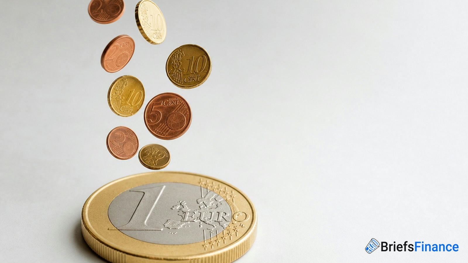 Several Euro coins of different denominations are falling near a large one Euro coin, with the BriefsFinance logo in the bottom right corner.
